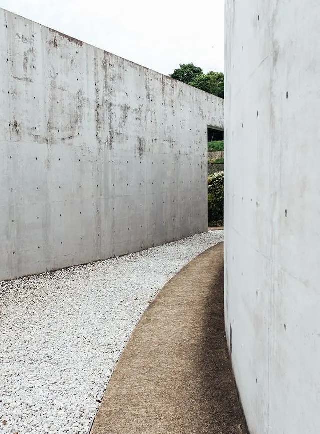 Water Temple by Tadao Ando, [lotus pond exterior / concrete wing walls / descent staircase / vermilion sanctuary interior / light court / Awaji Island hillside context], 1991 Japan