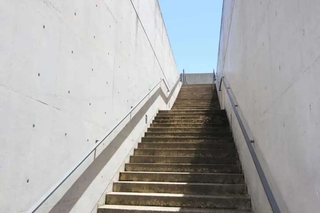 Water Temple by Tadao Ando, [lotus pond exterior / concrete wing walls / descent staircase / vermilion sanctuary interior / light court / Awaji Island hillside context], 1991 Japan