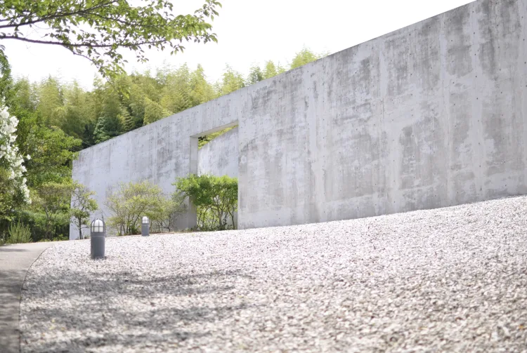 Water Temple by Tadao Ando, [lotus pond exterior / concrete wing walls / descent staircase / vermilion sanctuary interior / light court / Awaji Island hillside context], 1991 Japan