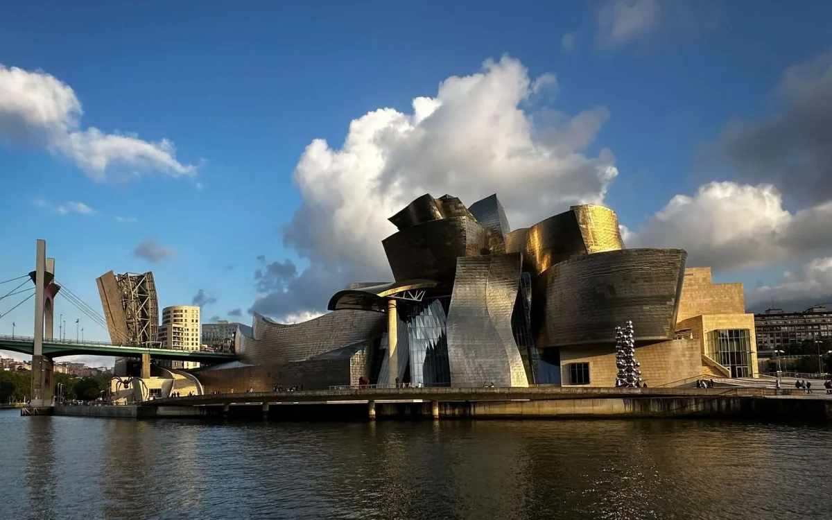 Guggenheim Museum Bilbao by Frank Gehry, [titanium facade / atrium / river view / Salve Bridge / Richard Serra gallery / aerial view], Bilbao Spain 1997