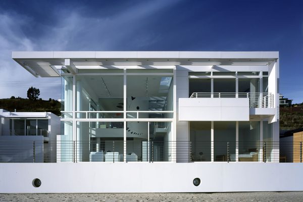 Southern California Beach House by Richard Meier and Michael Palladino, [exterior courtyard / glazed bridge / double-height living room / ocean facade / sunscreen louver detail / entry wall], Malibu California 2001